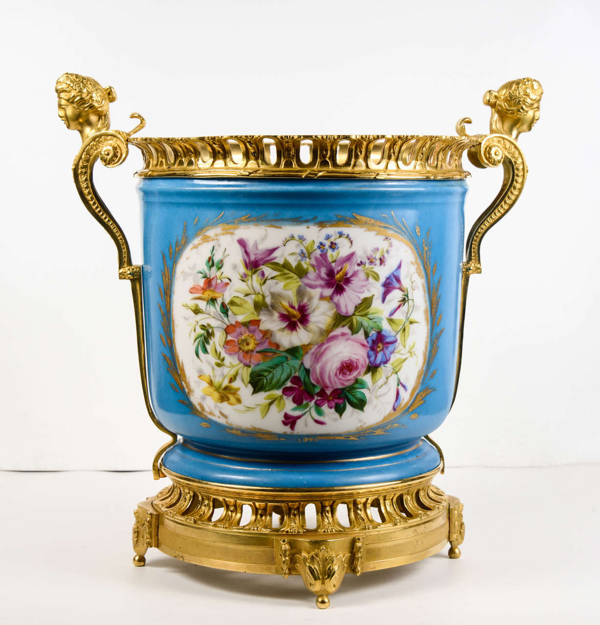 Blue vase, manufacture of Sèvre, on a gilded bronze base, with gilded bronze handles 
flowers painted on one face, and spring scène on the other face.