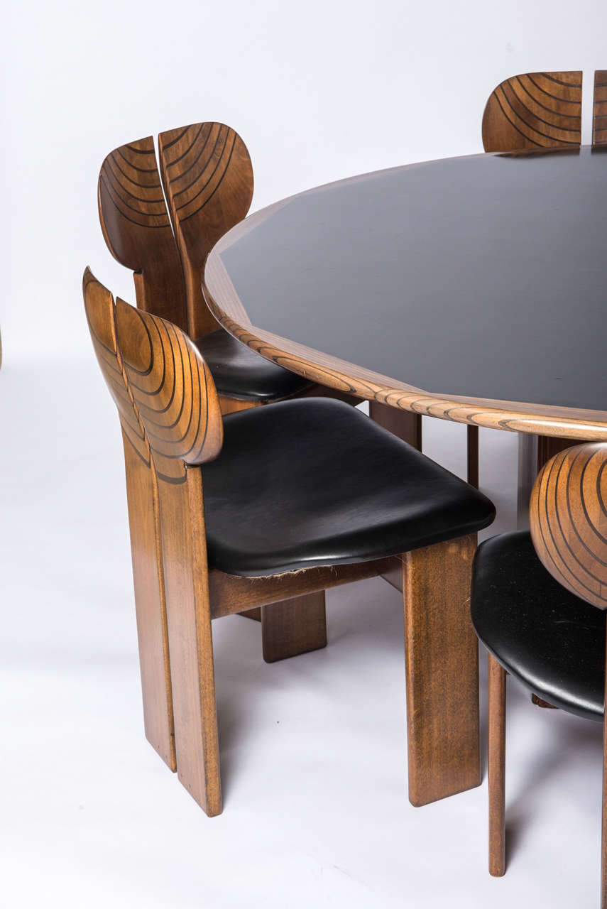 A rare “Artona” dining suite designed by Afra and Tobia Scarpa, for Maxalto in 1975 .
Walnut with ebonized inlay. Retailed by Liberty, London.
The circular table raised on a square plinth base with original cement ballast.
Labelled “Contrappeso