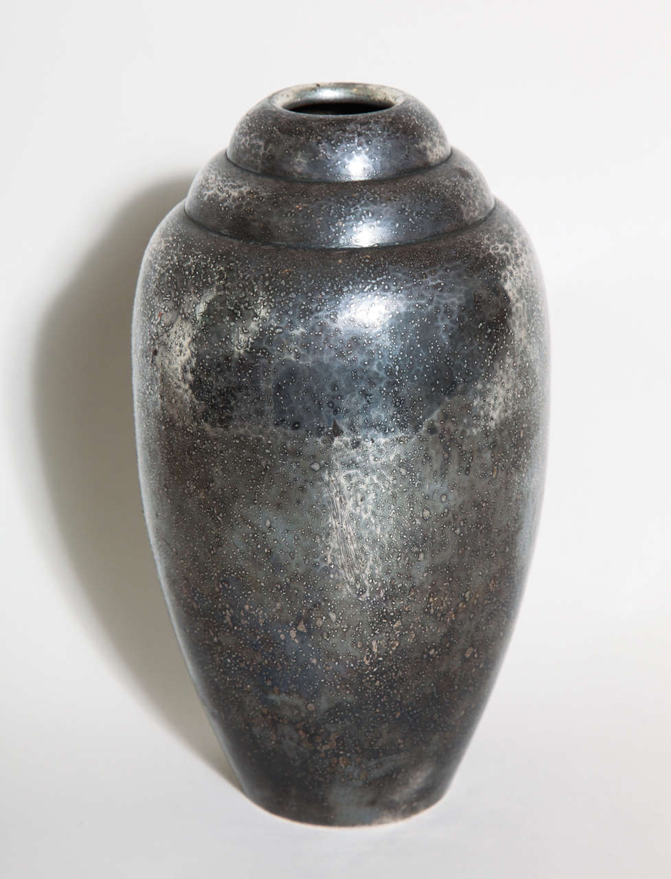 Ovoid maillechort and copper vase with double recessed arch neck and silver/black pebbled patina

Impressed Christofle/ B61D underneath.

(Price shown is reduced price, no further trade discount)