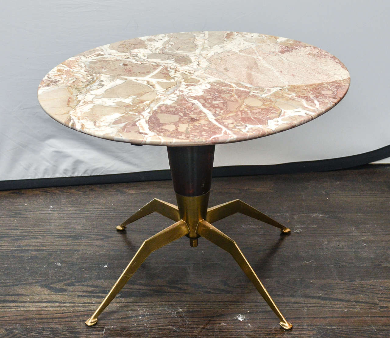 Elegant marble-top side table with tapered mahogany base on solid brass spider legs.