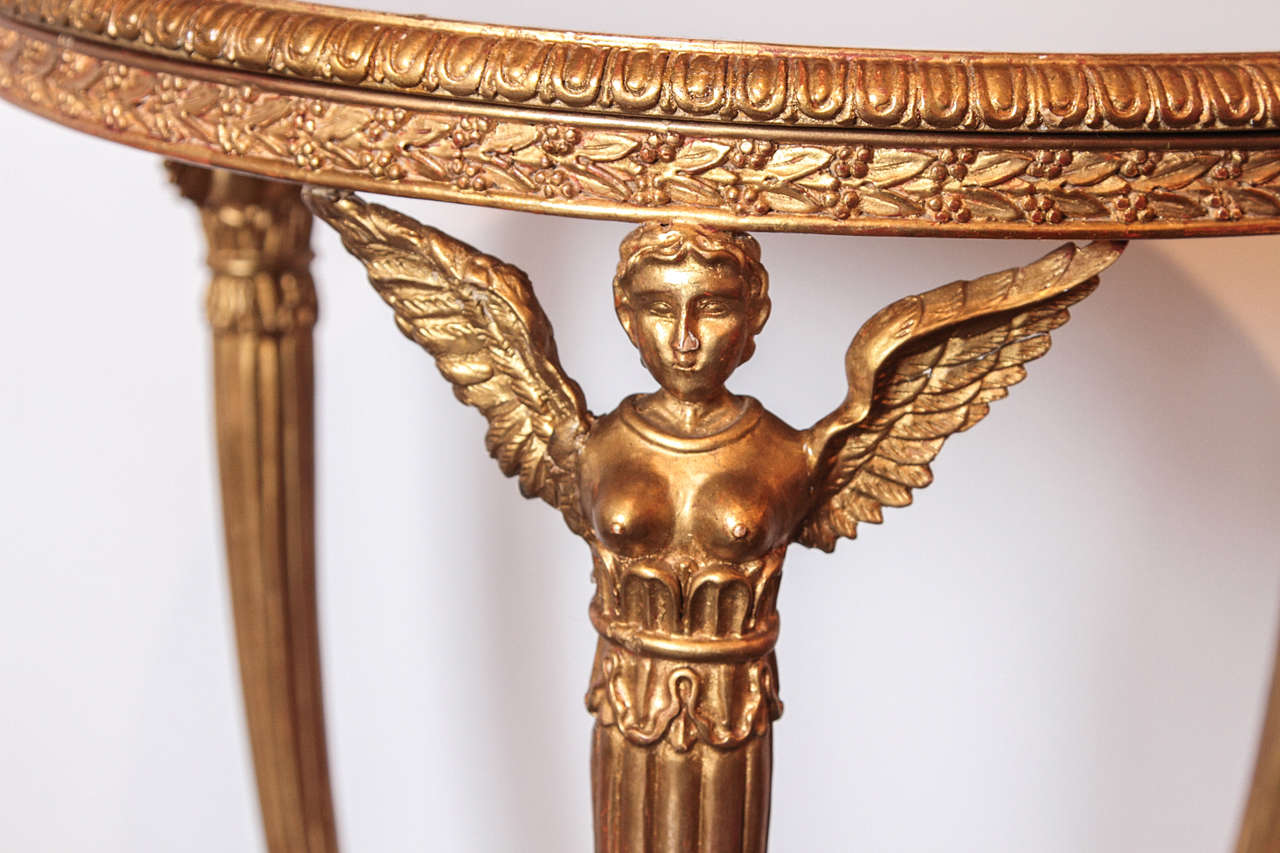 Pair of Empire style carved and gilt tables with glass tops In Excellent Condition In Dallas, TX