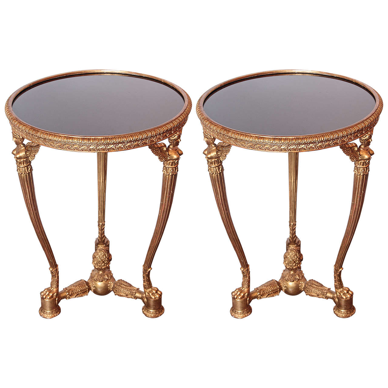 Pair of Empire style carved and gilt tables with glass tops