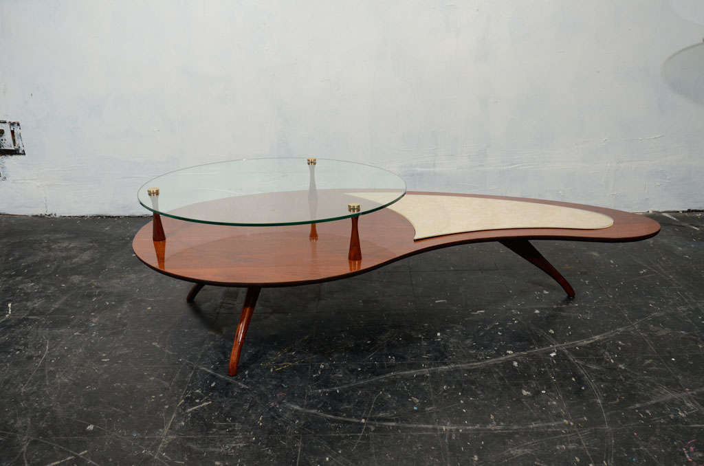 Beautiful biomorphic kidney shaped walnut cocktail table,probably designed by Paul Frankl,with three legs in very good conditions.