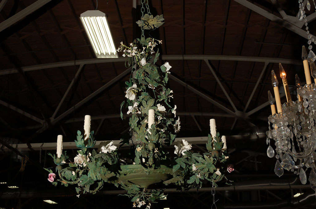 This big Italian tole chandelier looks like something out of Brooke Astor's sunroom. It is magnificent, with just the right amount of age wear.It was recently mishandled, so I had it completely restored. It is covered with tole leaves, bisque