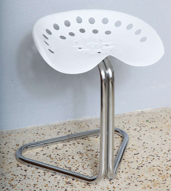 Slick, tongue-in-chic stool has a gleaming white powder-coated tractor seat cantilevered over a polished chrome base. Perfect for desk, vanity, or as kitchen utility seating.