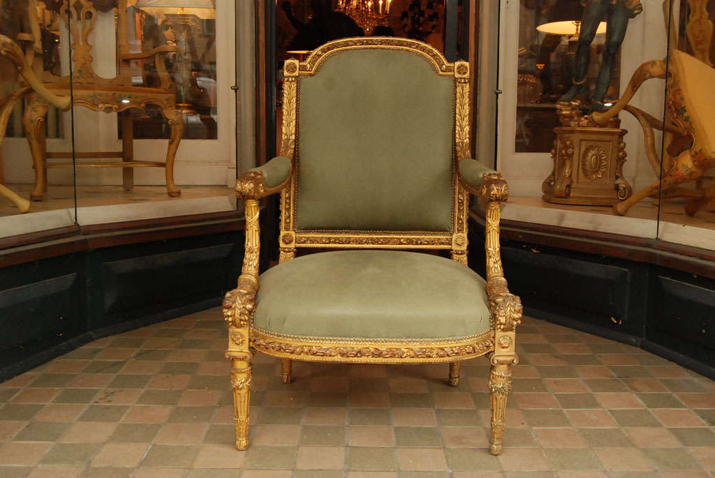 An impressive Louis XVI style highly decorated gilt arm chair of exceptional quality and scale. The chair is upholstered in embossed green leather.

