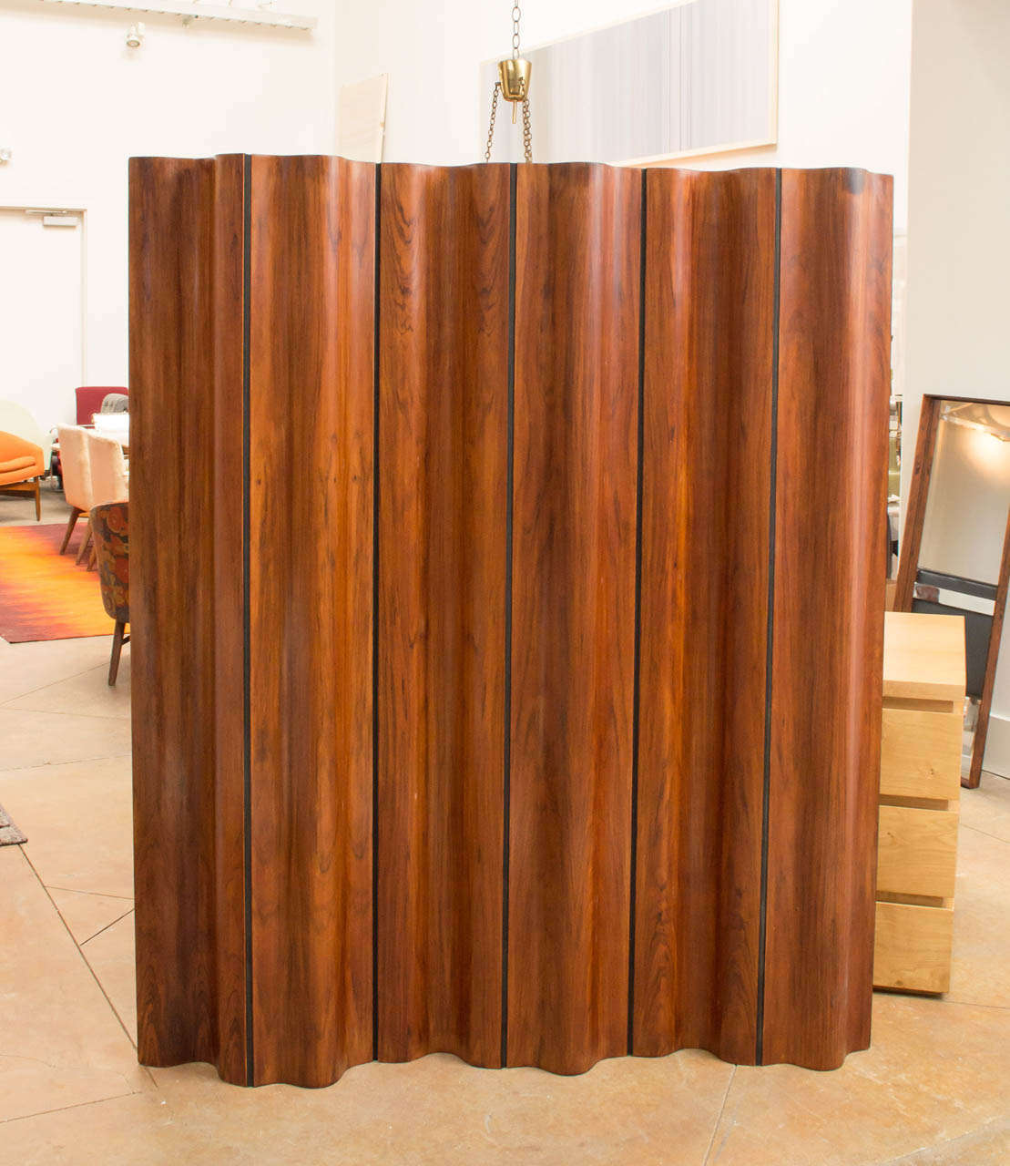 A distinctive, yet playful wave-shaped room divider/ screen. Rare, late edition rosewood. Design from 1946. 68-inch-high, portable and foldable. Marked accordingly on brass in upper corner. Number 59 of 500
