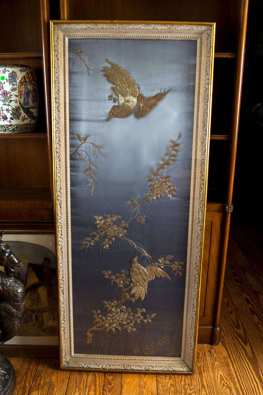 Pale blue silk with hand sewn golden threads of
birds and branches. Set in a simple gilt wood frame behind glass.
Please contact dealer directly.