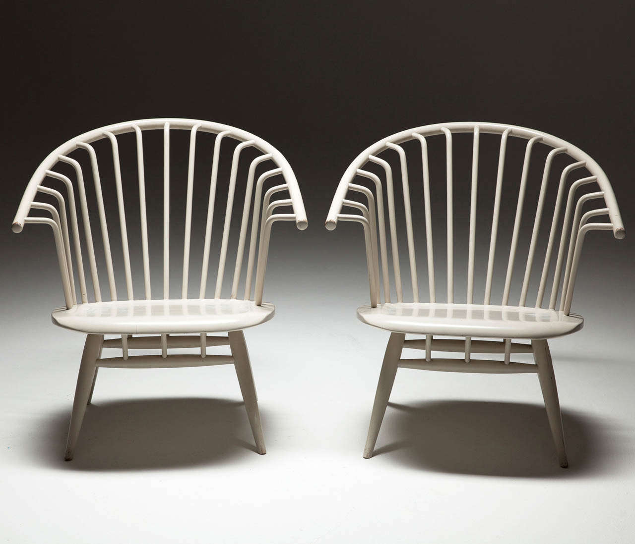 Very nice conditioned pair of early 'Crinolette' chairs designed by Ilmari Tapiaovaara, made by Asko, Finland. Made in the 1960's.

This matching pair forms a interesting and fresh couple which adorns any modern or classic interior.

Very