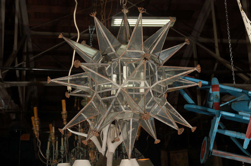 C. 1960 glass and metal star chandelier. Have always loved star chandeliers, and this one is no exception. Many glass panels on many arms, with metal spacers. It just twinkles when it's lit. These star chandeliers are often found in Spanish homes,