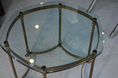 Neoclassicial brass hoof foot glass topped table by La Barge.
