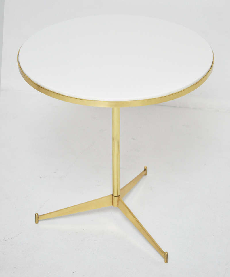 Paul Mccob designed cigarette tables for Directional. Brass bases with white Vitrolite glass tops.
