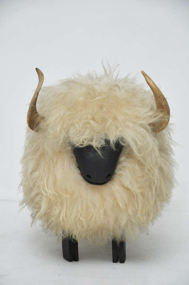 Decorative sheep in the style of Lalanne.  Long hair fur coat with horns over wooden body.