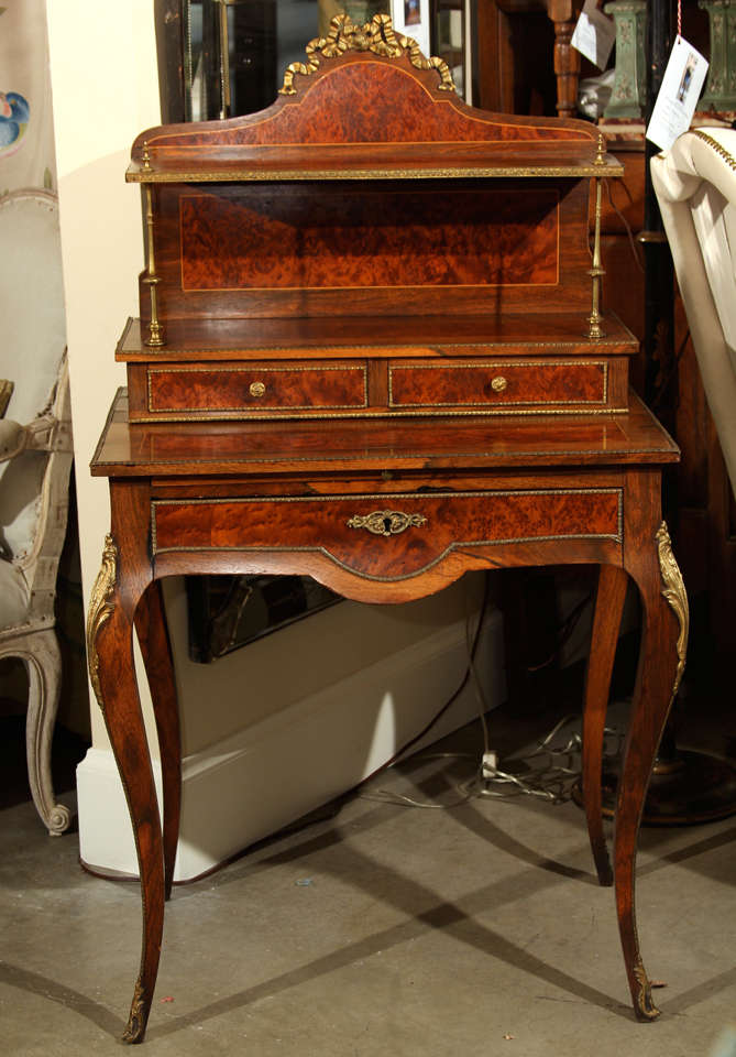 A late 19th century French Louis XV revival ladies walnut writing desk with ormolu mounts and trims