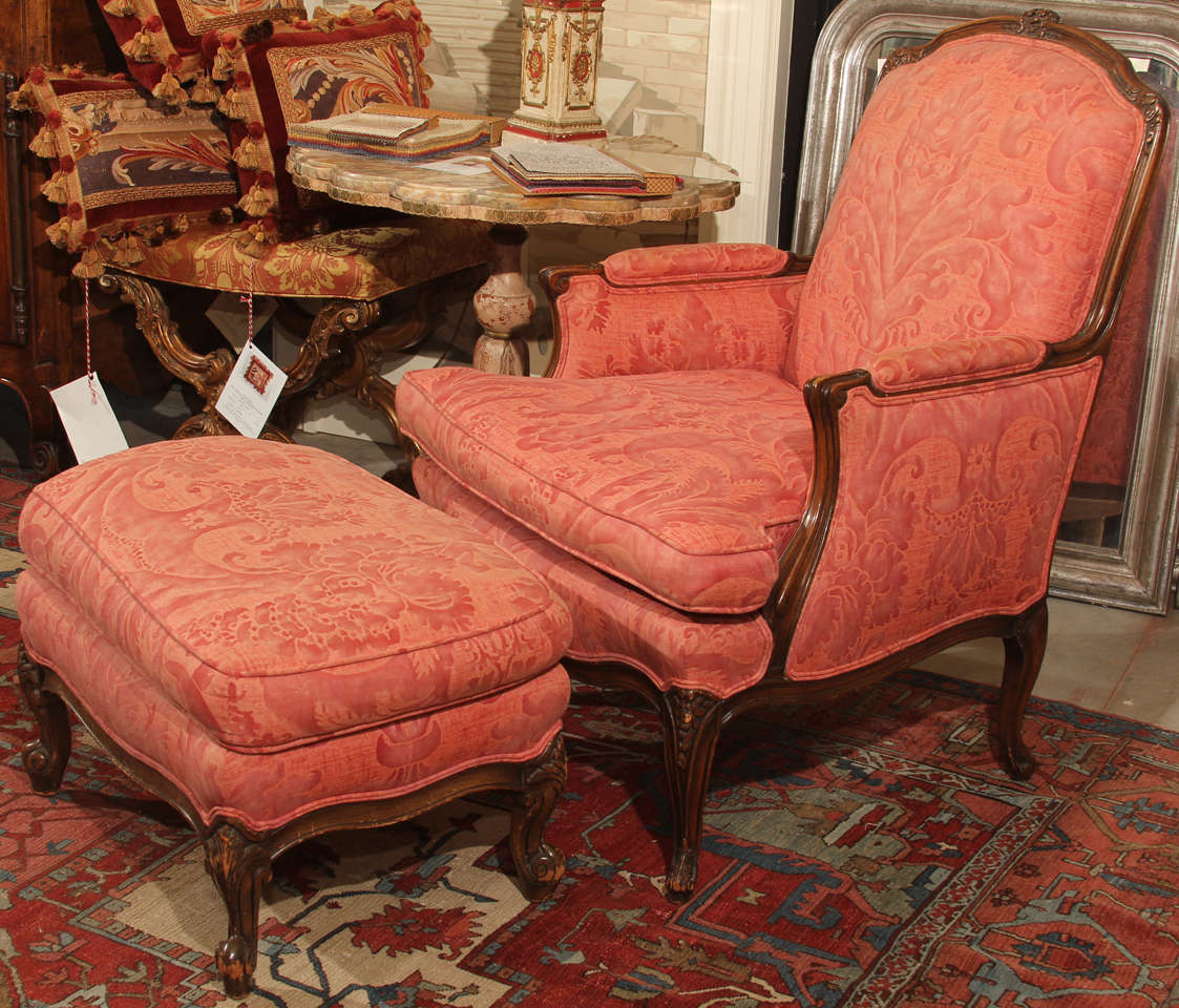 A vintage Louis XV style chair and ottoman upholstered in vintage Fortuny fabric
The arm height is 25' and the seat depth is 22