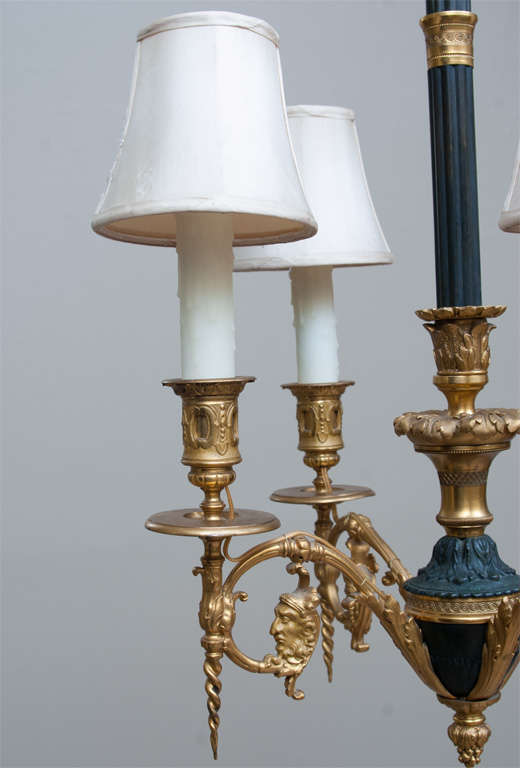 This unique and intricate chandelier  is hand-cast, superbly detailed with outstanding proportions. Restored and rewired by us. Polybeeswax candle covers. Lovely patina. Mounting hardware and chain included in the price.