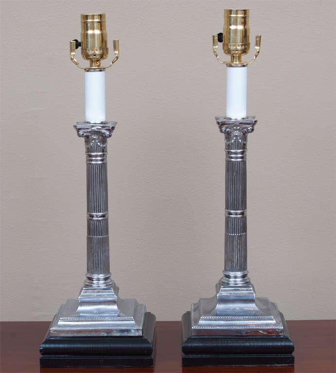 Pair of Edwardian Corinthian column silver plate sticks made into lamps in the latter 20th Century. Modern wiring. Shades included.