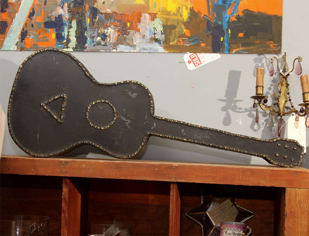 folk art metal guitar- was made as a planter, but sits flat, so it can rest on tabletop or shelf, or hang on wall or fence.