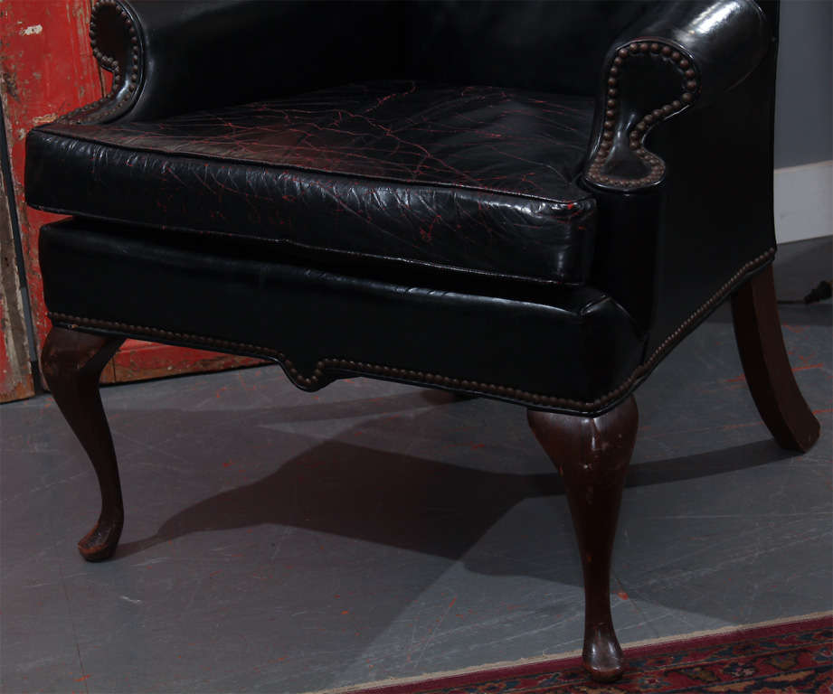 black leather wingback chair with touches of red in seat In Good Condition In Seattle, WA
