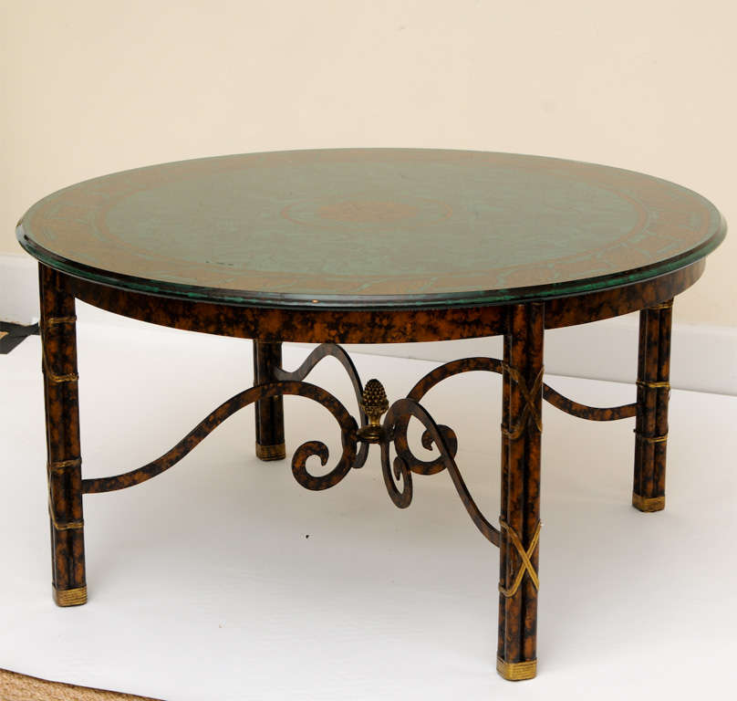 This wonderful Fornasetti style reverse painted malachite, fern and rope glass top table is embellished with a faux painted tortoise and brass wrapped X's for the base of the table. it has a scrolled
and acorn decorated base.

Versace meets