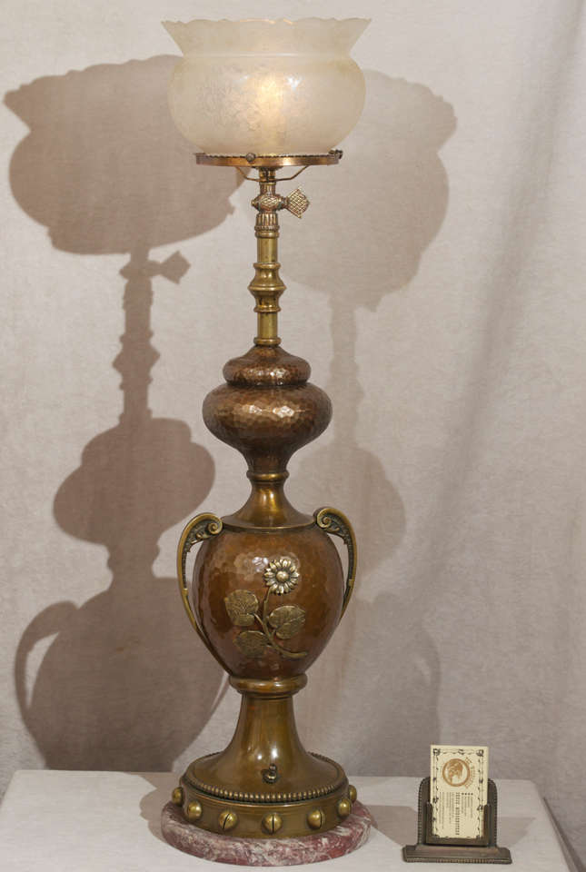 This is a superb example of the aesthetic movement.  This newel post lamp consists of hammered metal with high relief flowers and is mounted on a rouge marble base.  The period gas shade is a perfect match, having deep etched flowers.  Has been
