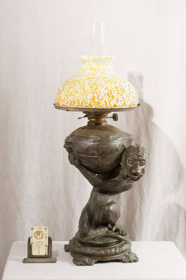 This amazing 19th Century figural lamp is most assuredly going to put a smile on your face every time you look at it.  We have had some nice lamps from this period, but this one is certainly one of the best.  The monkey has glass eyes and a period
