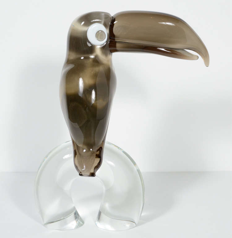 Spectacular  smoked and clear hand blown Murano glass executed by hand in the best tradition of one of the great masters Licio Zanetti. The base the Toucan is perched on is Hand signed on the bottom by Licio Zanetti as well
Licio Zanetti is