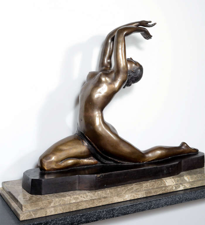 This stunning bronze epitomizes the Art Deco era in France. It depicts a Dancer of the 1920s. It is bronze and rests on an exotic marble two tiered stepped base. Stylized Art Deco features on the beautiful dancer.It is signed by the noted Art Deco