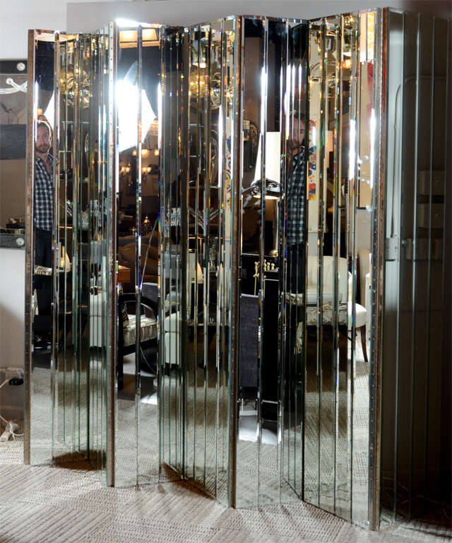 This stunning screen features hand beveled vertical panels. The screen is comprised of 4 panels which can be figured and adjusted many differents ways or even separated.The back is finished in silver leaf.