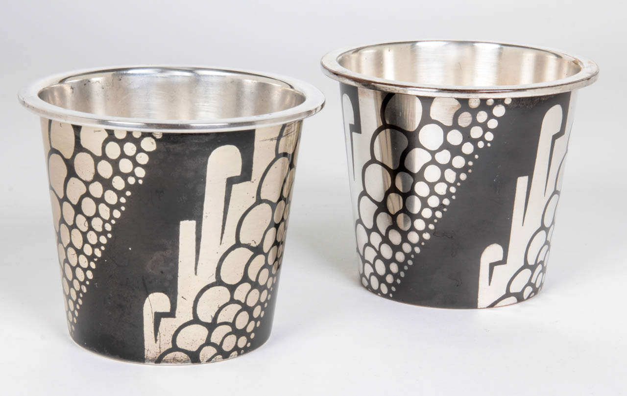 RUDOLF RIEGER   Germany
WMF [WÜRTTEMBERGISCHE METALLWARENFABRIK]  Geislingen, Germany

Dinanderie pair of vases c. 1930

Brass with a black patina and stylized silver inlay in a geometric motif

Marks:  WMF castle mark

Illustrated: WMF