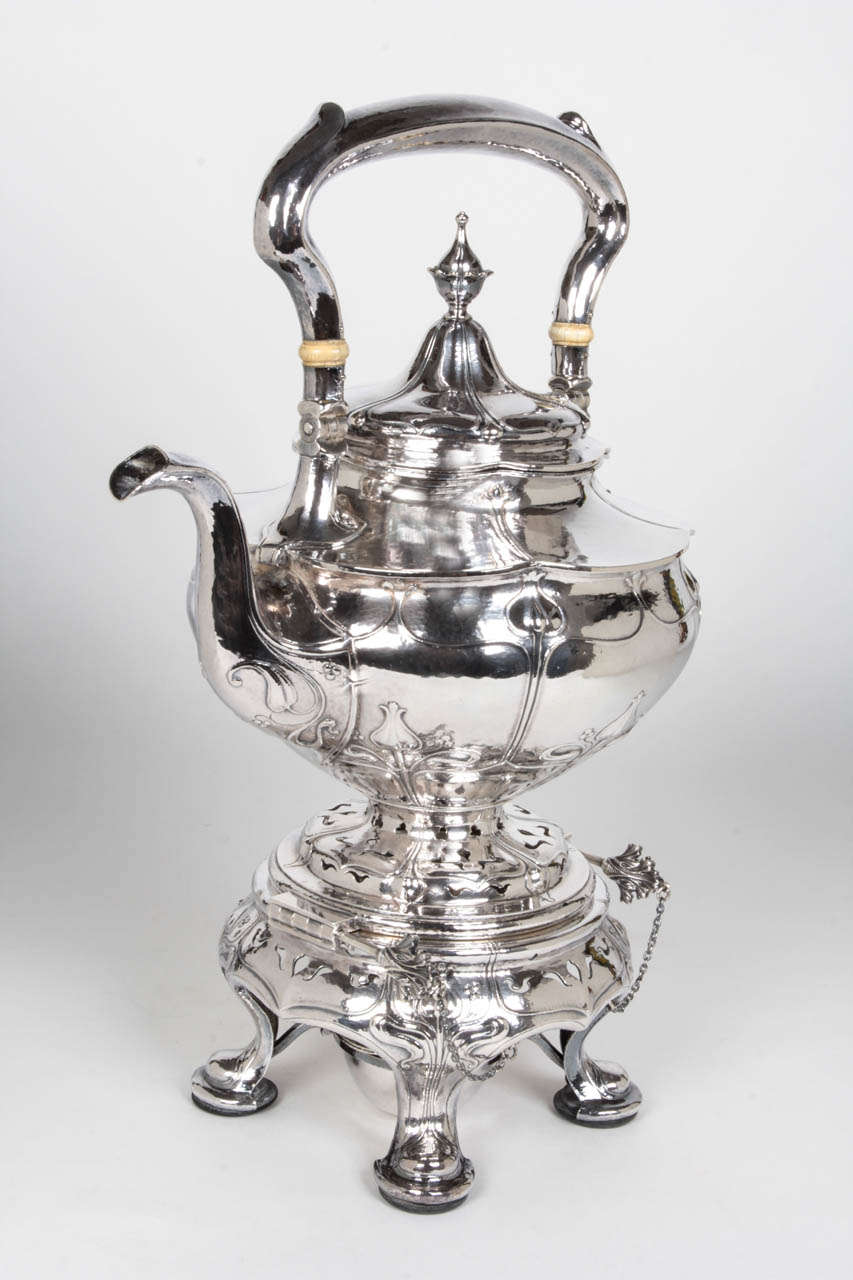 GORHAM MFG. CO SILVERSMITHS Providence, RI
FINN ERICHSEN (Maker)
WILLIAM T. THOMPSON (Chaser)
SPAULDING & CO (Retailer) Chicago, IL

Kettle-on-stand c. 1903

Completely specially handwrought sterling silver in an overall organic form with