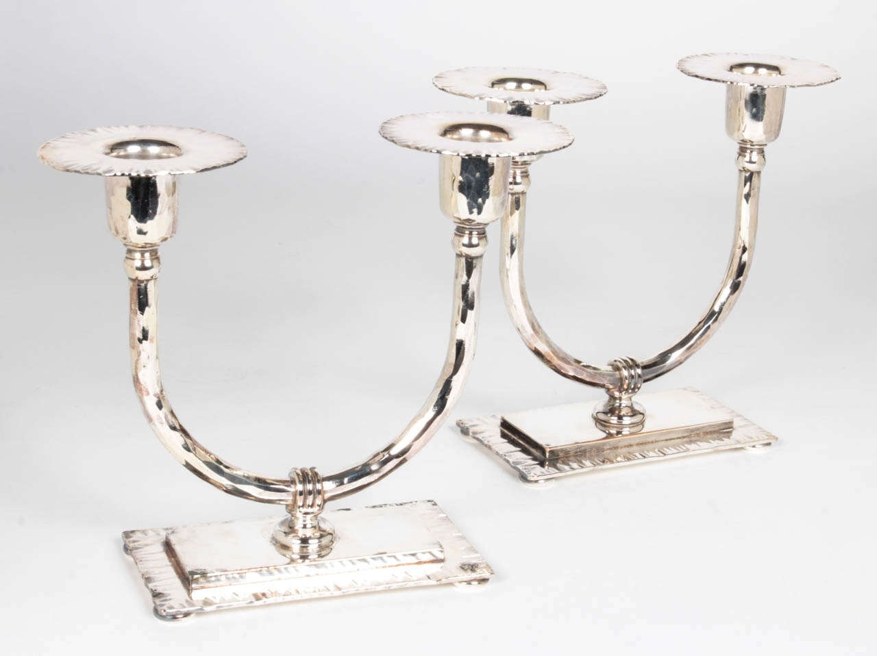 ROYCROFT COPPER SHOP East Aurora, N.Y.

Pair of candlesticks c. 1915.  

Hand wrought and textured copper, silver-plated.

Marks: impressed R, in orb with cross, ROYCROFT

For more information see: The American Arts & Crafts Movement in