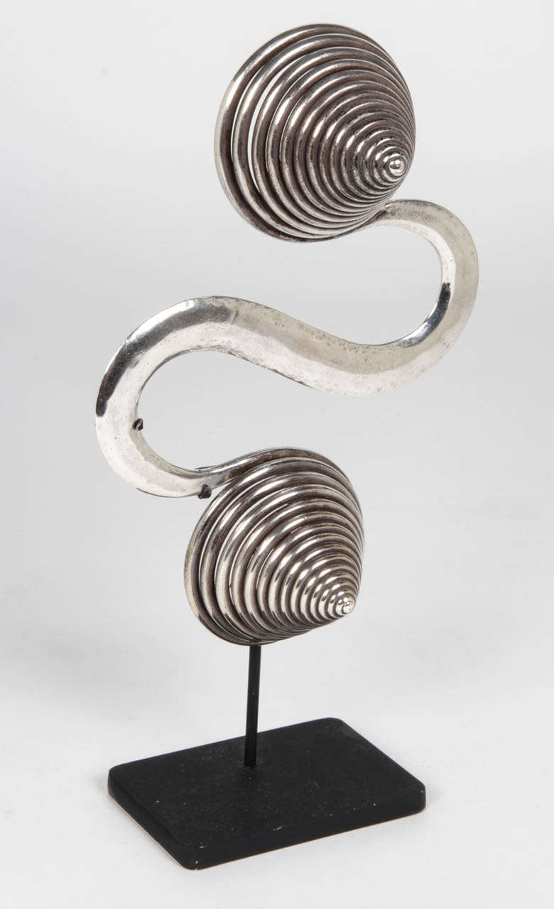 Dong or Meow People / Spiral silver counterweight 20th Century