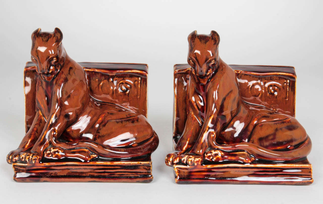 MARGARET HELEN MCDONALD (b. 1920)  USA
THE ROOKWOOD ART POTTERY  Cincinnati, Ohio, USA

“Panther” bookends  1936

A pair of high-fire pottery bookends in shape of cats with a rare goldstone glaze.

Marks: Rookwood “RP” insignia surrounded by