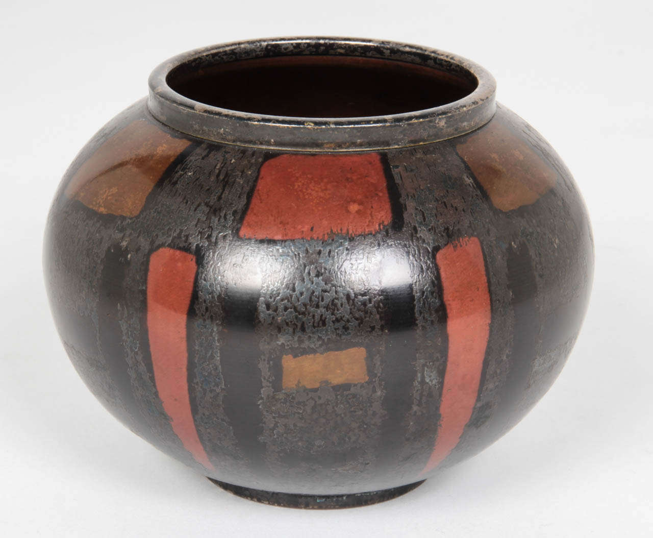 WMF  (Württembergische Metallwarenfabrik)  Geislingen, Germany

Dinanderie vase  c. 1930	
	
Silver-plated copper with with red patinated squares and rectangles on a black-patinated textured background 

Marks: WMF castle mark, IKORA