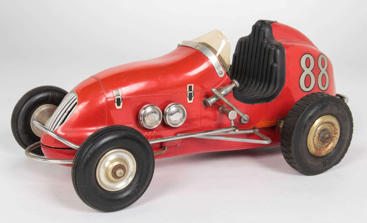 OHLSSON & RICE (founded 1941) Los Angeles, CA
Tether Race Red car Model No. 88

Gas powered tether car racer 1950

Steel and various metals with the car and trailer details painted red, rubber tires and cork details

The license plate reads:
