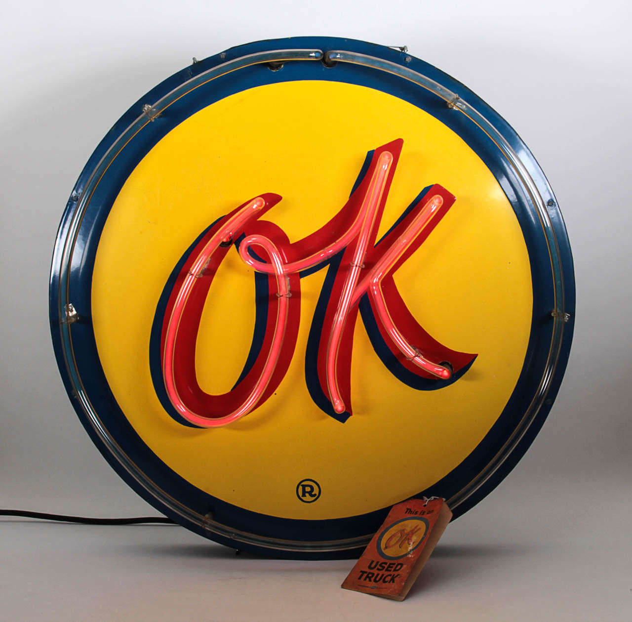 AMERICAN NEON DESIGN

OK Chevrolet Used Truck Sign  c.1940’s

Blue, yellow and red baked enamel on metal with an orange neon tube spelling out “OK” encircled with a round blue neon border, original paper tag. 

Marks: Registration Mark (in the