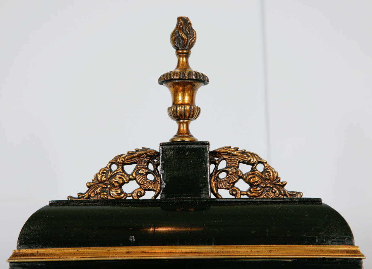 A fine George III period ebonised and brass mounted automata bracket clock by Thomas Grinnard, London.  This imposing bracket clock in its moulded ebonised case, with its bell top, and topped with a brass urn flambeau finial, flanked by pierced