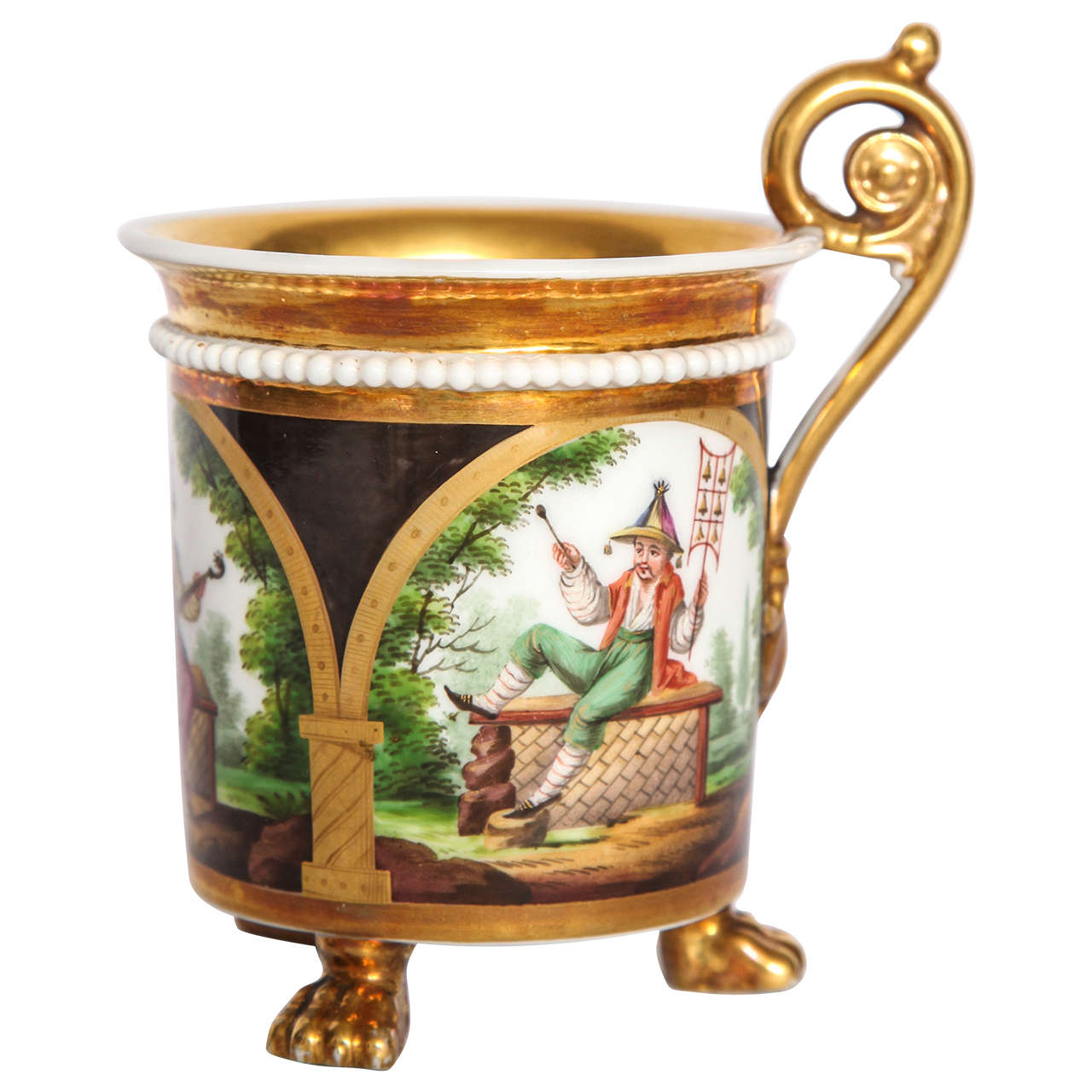Paris porcelain gilt chinoiserie cup.   French footed coffee can with richly painted and gilt chinoiserie figures within gilt arcade on brown ground with gilt Interior.  France, early 19th century. 
Dimension: 5