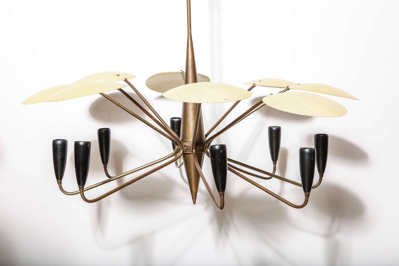 Italian Modern Gino Sarfatti for Arteluce Hanging Pendant, 1950's. Featuring a round single tier eight arm form, eight enameled Black sockets and eight perforated Creamy Yellow enameled metal disc diffusers, central rocket Brass column. With eight