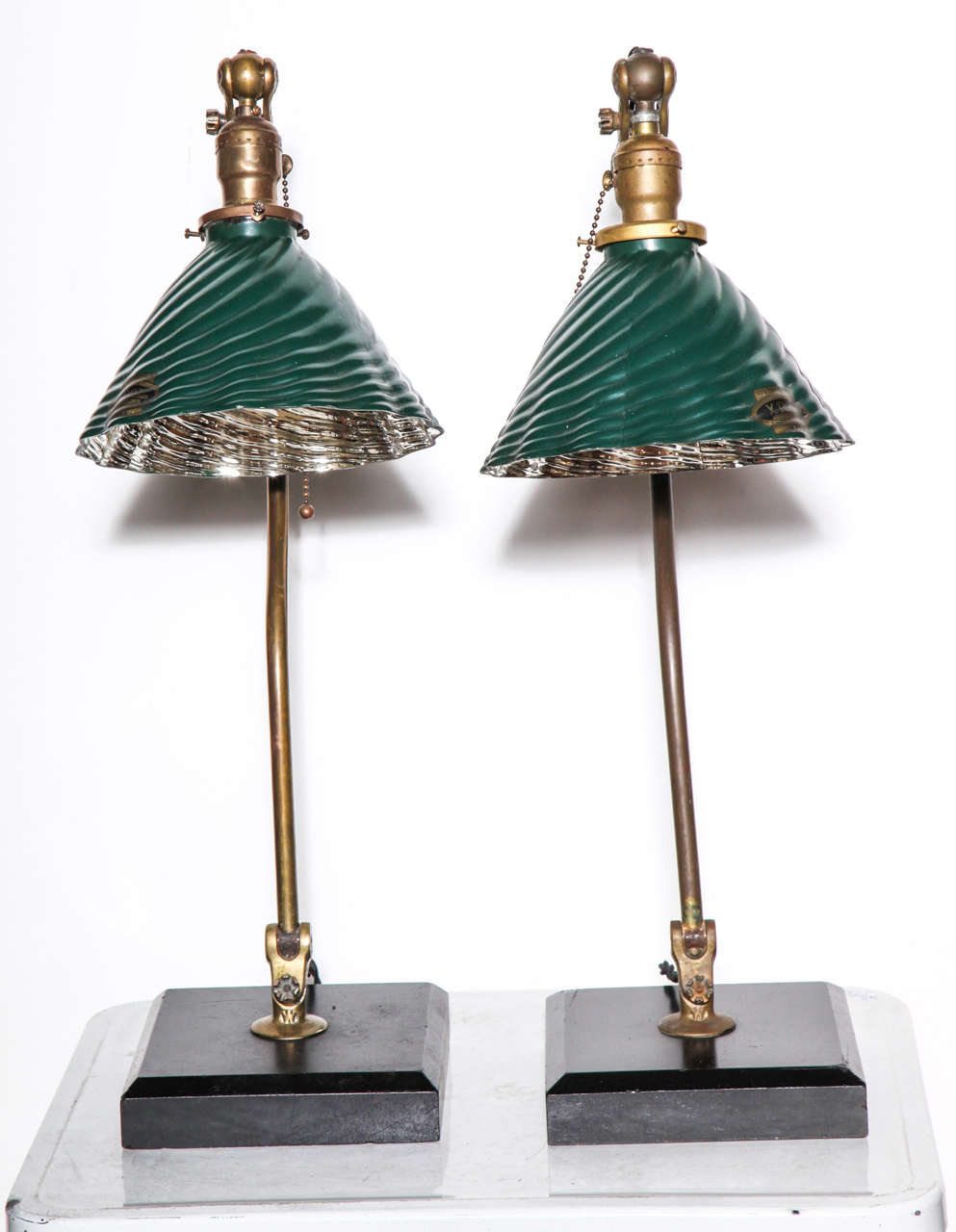 Early Pair of O. C. White Adjustable Reading Lamps. Featuring curved, articulating Brass stems, square Black enameled Slate bases and age appropriate scalloped shell XRAY Green Mercury Glass Shades (Green exterior, Silver interior). Tilt at Shade