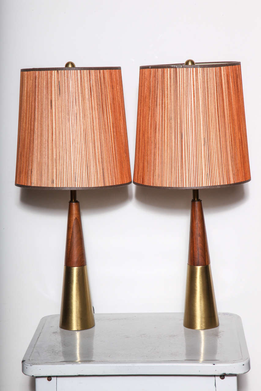 1950's Tony Paul for Westwood Studios Table Lamps in Brass and Solid Walnut.  Featuring a slender and sleek conical form with Walnut top and Brass base with vintage wooden detailed Shades (11W x 11.5H) not original to Lamp. Original solid Brass