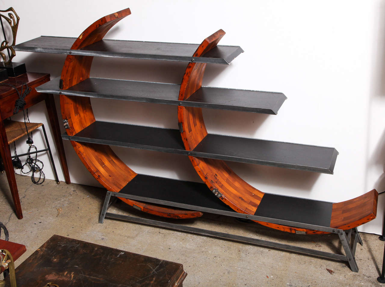 1980s custom studio Display Piece utilizing an Industrial 19th century Maple patent mold with steel rimmed Black Micarta surfaces. The bookcase has three open levels with ten display areas (top 7.5 x mid 9' D x bottom) 11
