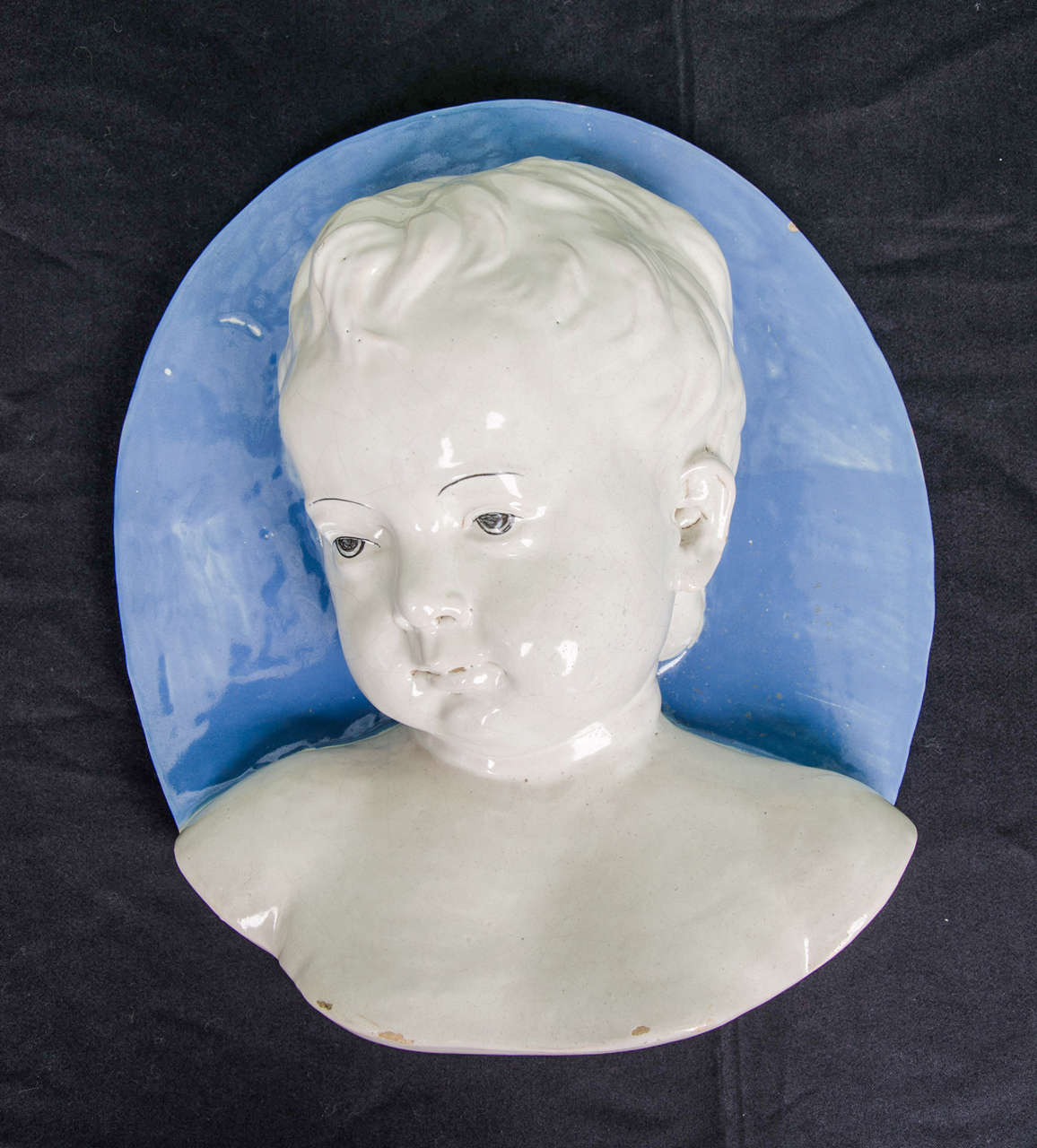 A beautiful round Plaque depicting the bust of a young boy in the 