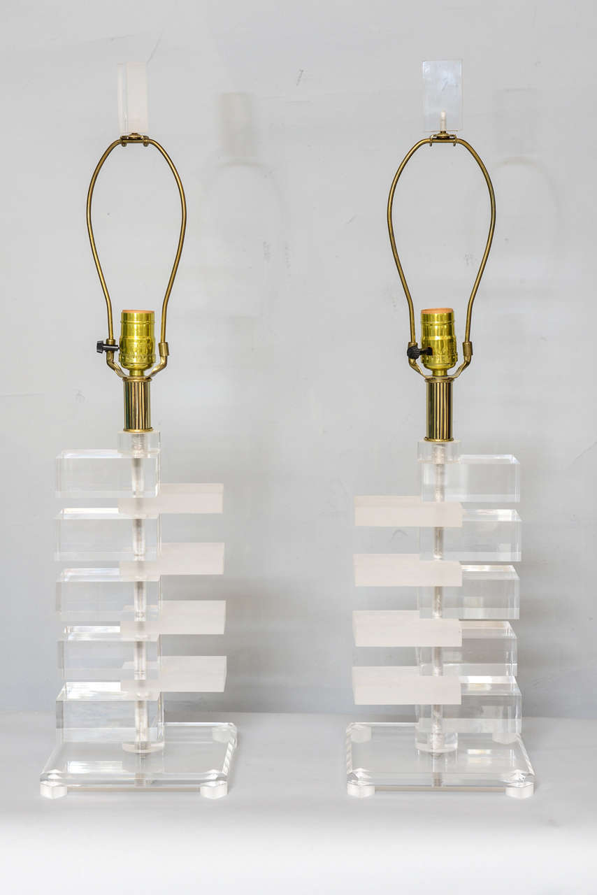 Pair of lamps, of movable, alternating clear and opaque acrylic blocks, on square base, with matching finial.