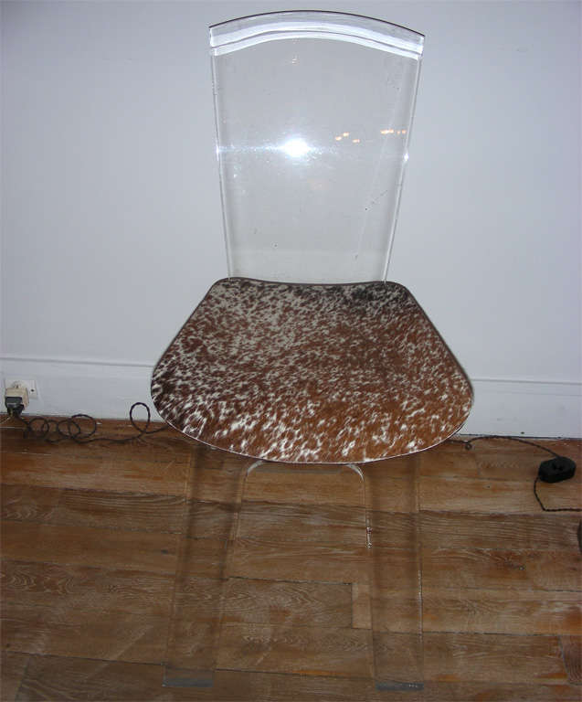 A suite of four striking acrylic chairs