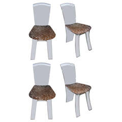 A suite of four striking acrylic chairs