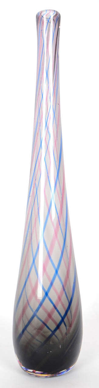 This tall, 47cm, tapering bottle vase is typical of the post war style of Venini. Made of pale amethyst glass with internal blue and pink spiral lines, the acid etched Venini , Murano signature can just be made out on the underside.