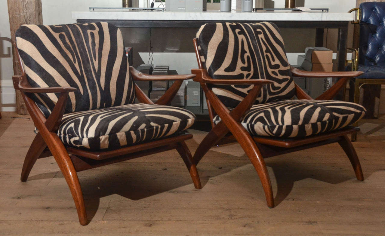 Beautiful pair of 1960's teak Danish armchairs in the style of Finn Juhl newly re-upholstered in a cow hide zebra.