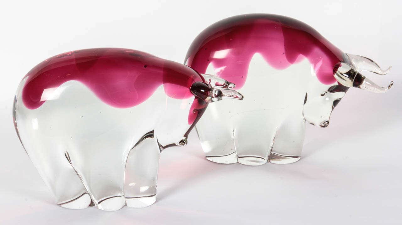 Fantastic pair of clear and magenta hand blown glass bulls by Salviati. Great as bookends or decorative objects .